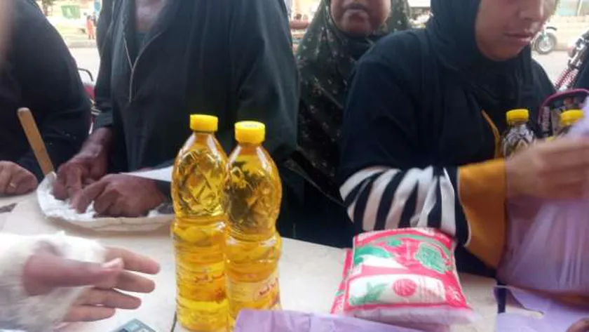 مواطنون يتسلمون بعض السلع تموينية .. أرشيفية